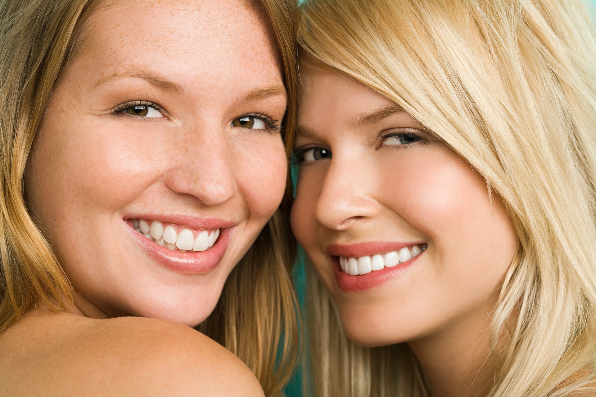 Two smiling blonde women