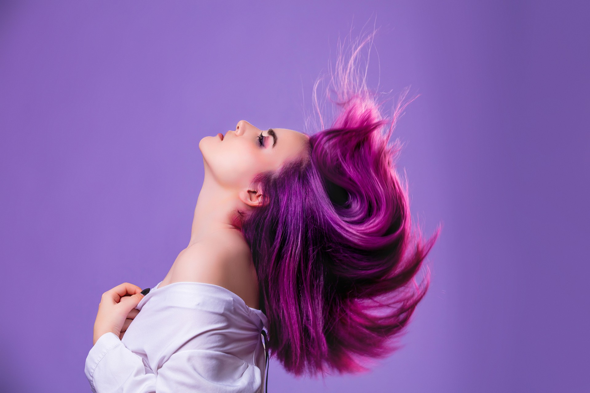 Model girl young beautiful stylish with hair dyed purple on violet background